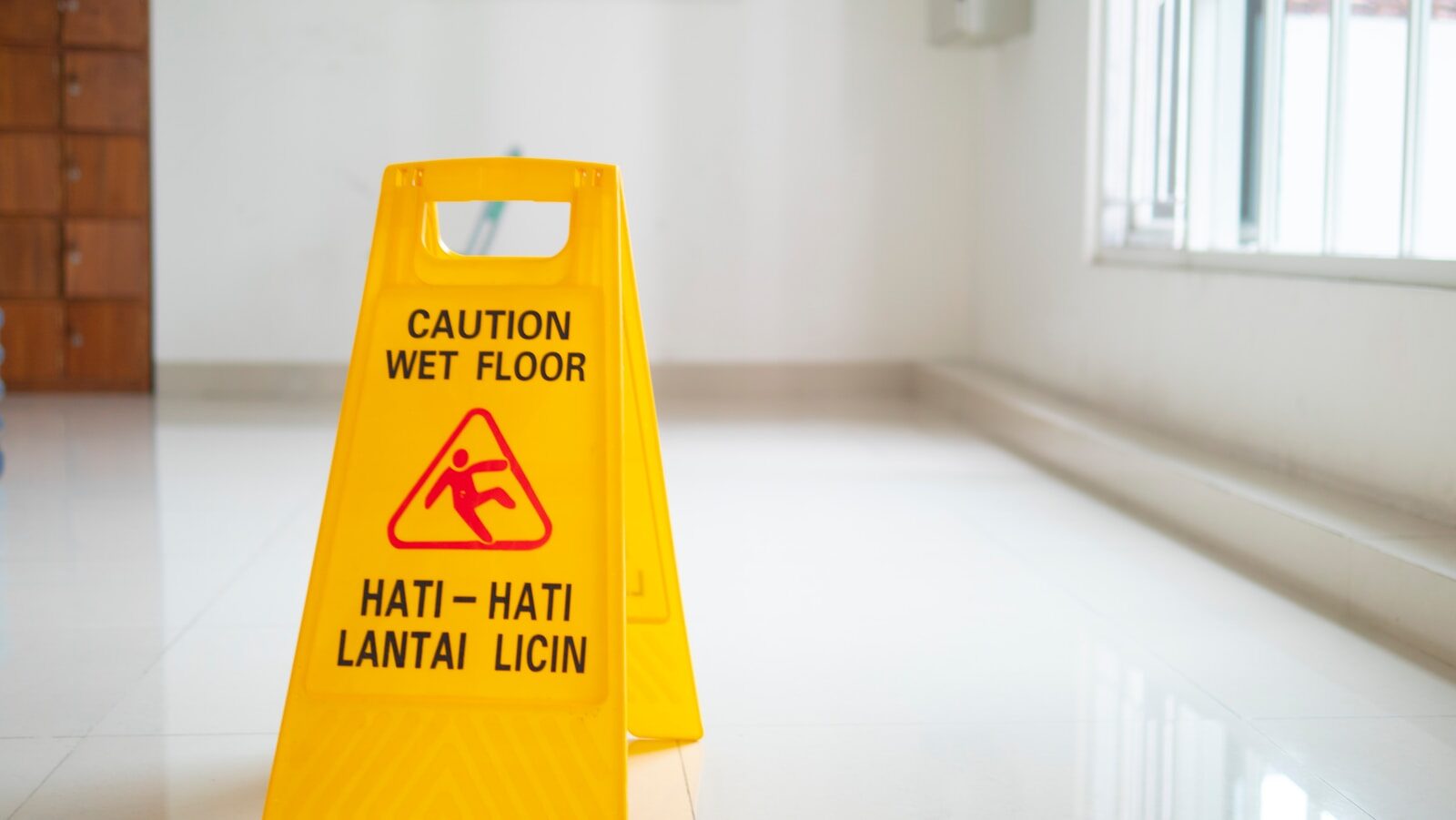 a yellow sign on a white surface
